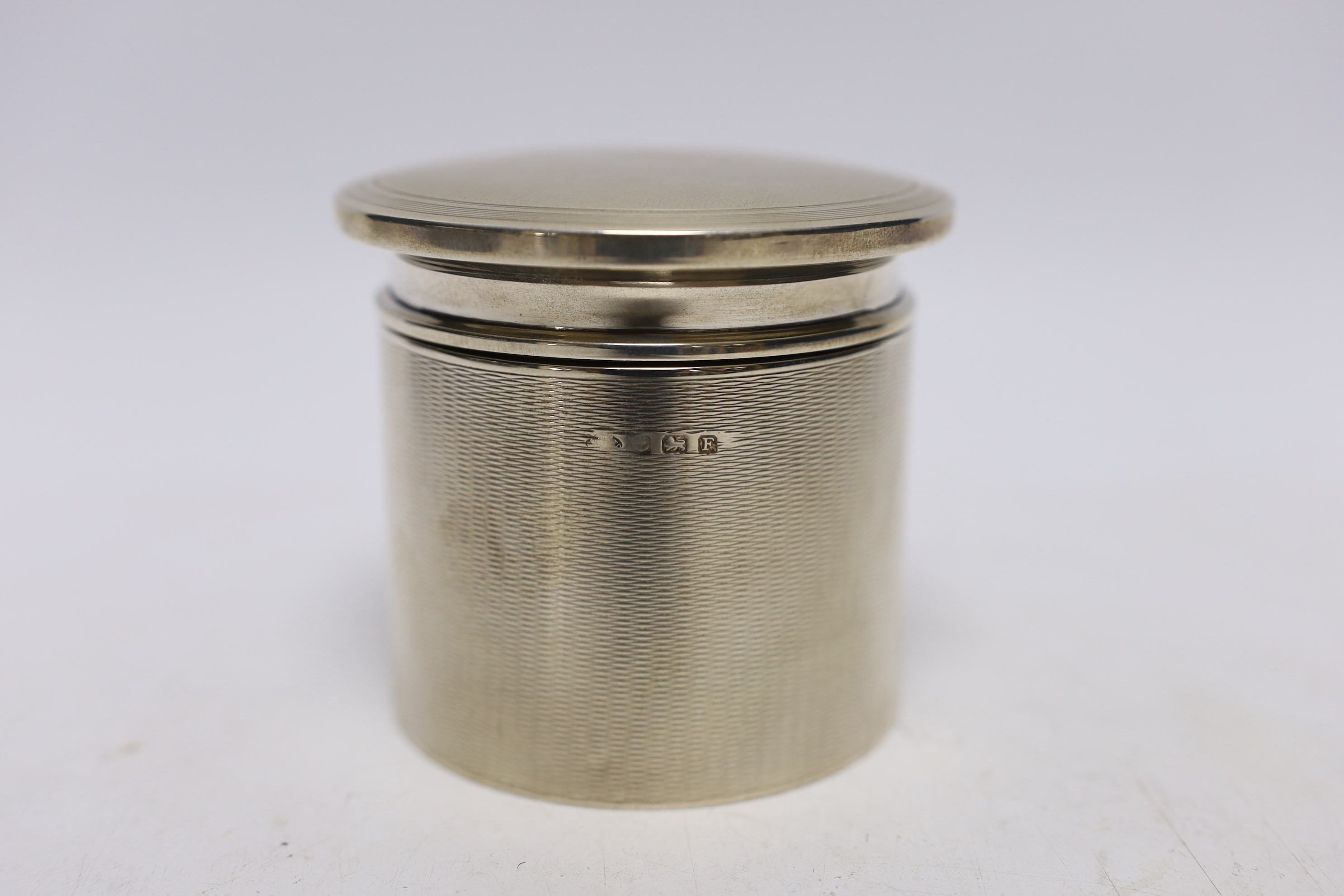 A George V engine turned silver toilet canister and cover by Adie Bros. Birmingham, 1930, height 76mm, 5oz.